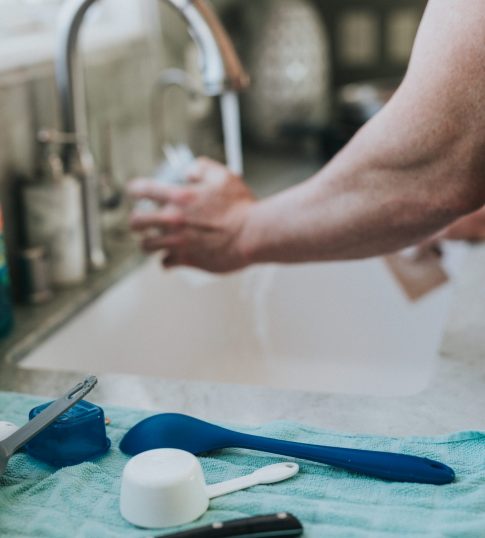 person washing hands on sink